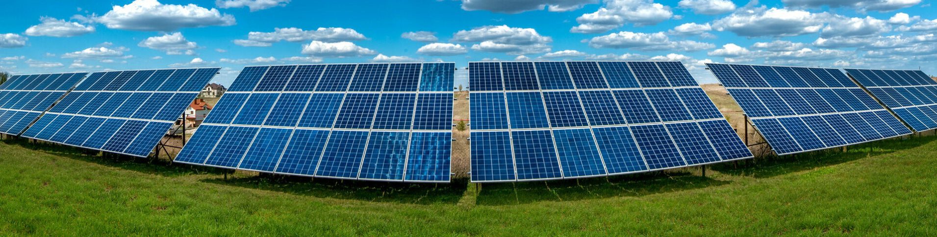 Solar energy panel system power at green field and sky with clouds